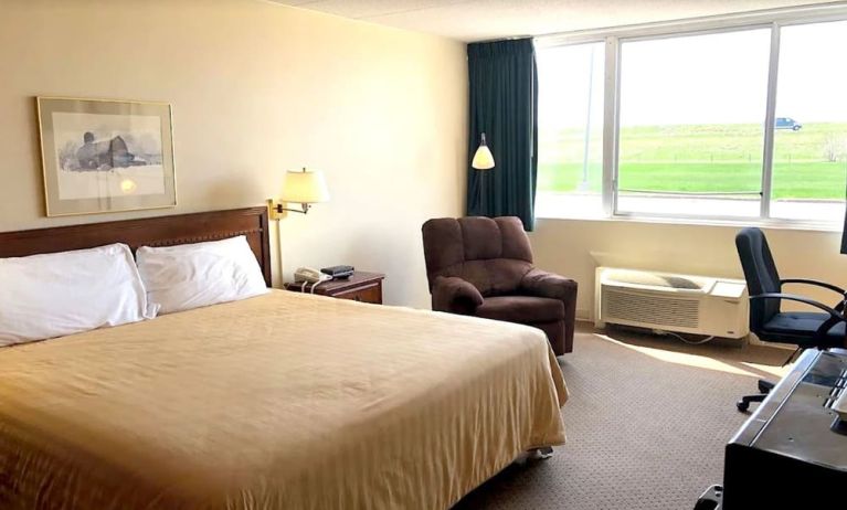 Bright and spacious day use room with work desk and sofa at Norwood Inn And Suites Worthington.