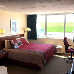 King suite with hot tub and work desk at Norwood Inn And Suites Worthington.