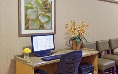 Business center with computer, printer and ergonomic chair at Norwood Inn & Suites Merrillville.