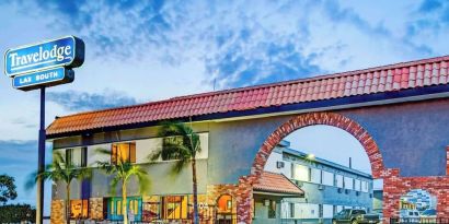 Hotel exterior and parking area at Travelodge LAX By Wyndham.