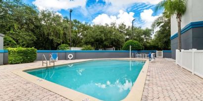 Outdoor pool at OYO Townhouse Orlando West.