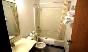 Private guest bathroom with combined tub and shower at Norwood Inn & Suites - Roseville.