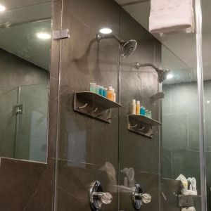 Private guest bathroom with shower and free toiletries at Hotel Chelsea, A South Beach Group Hotel.