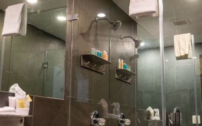 Private guest bathroom with shower and free toiletries at Hotel Chelsea, A South Beach Group Hotel.