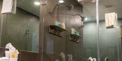 Private guest bathroom with shower and free toiletries at Hotel Chelsea, A South Beach Group Hotel.