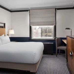 Standard room with work desk and TV screen at Hilton Orrington/Evanston.