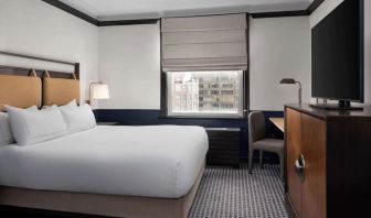Standard room with work desk and TV screen at Hilton Orrington/Evanston.