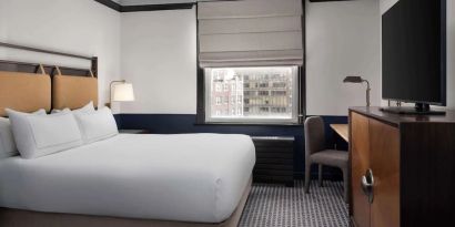 Standard room with work desk and TV screen at Hilton Orrington/Evanston.