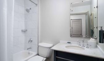 Private guest bathroom with combined tub and shower at Hilton Orrington/Evanston.
