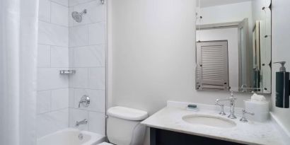 Private guest bathroom with combined tub and shower at Hilton Orrington/Evanston.
