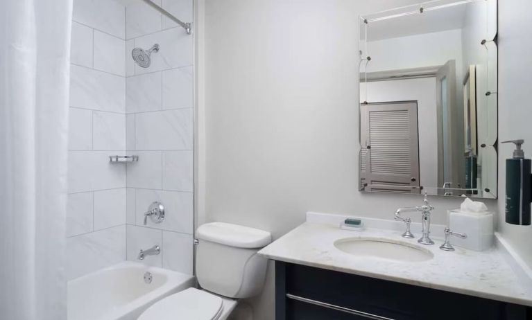 Private guest bathroom with combined tub and shower at Hilton Orrington/Evanston.