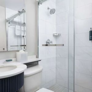 Private guest bathroom with shower and free toiletries at Hilton Orrington/Evanston.