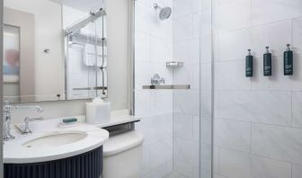 Private guest bathroom with shower and free toiletries at Hilton Orrington/Evanston.