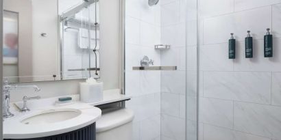 Private guest bathroom with shower and free toiletries at Hilton Orrington/Evanston.