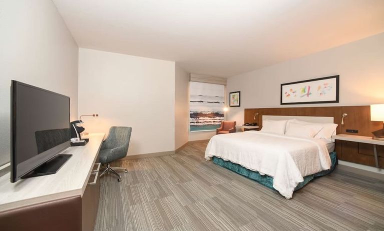 Spacious day use room with king bed, workdesk, TV screen and private bathroom at Hilton Garden Inn Cincinnati Midtown.