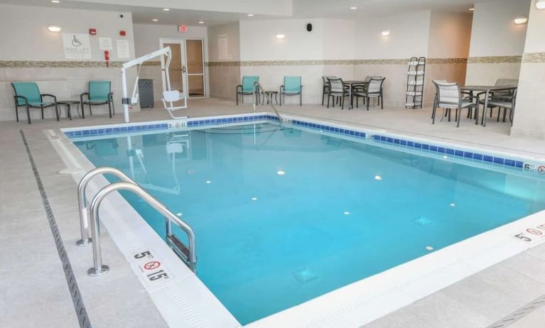 Indoor pool with lounge chairs at Hilton Garden Inn Cincinnati Midtown.