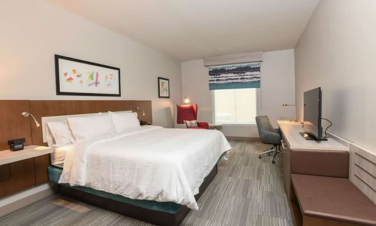 Bright and spacious day use room with king bed, work desk and TV screen at Hilton Garden Inn Cincinnati Midtown.