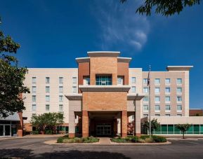 Hotel exterior and parking area at Hampton Inn & Suites St. Louis At Forest Park.