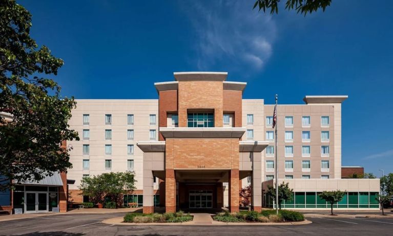 Hotel exterior and parking area at Hampton Inn & Suites St. Louis At Forest Park.