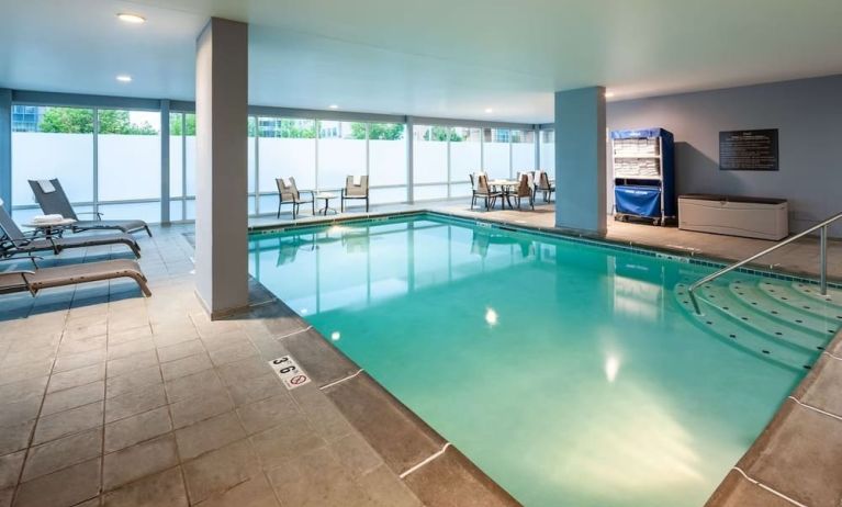 Indoor pool with lounge chairs at Hampton Inn & Suites St. Louis At Forest Park.
