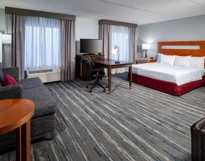 Day use room with king bed and workspace at Hampton Inn & Suites St. Louis At Forest Park.
