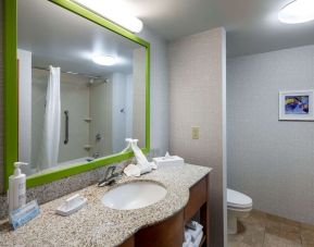 Private guest bathroom with shower at Hampton Inn & Suites St. Louis At Forest Park. 