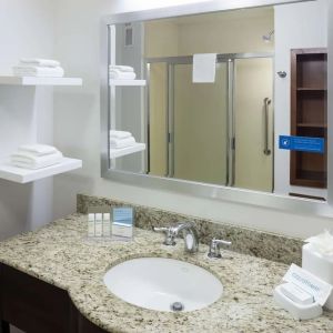 Private guest bathroom with shower and free toiletries at Hampton Inn Los Angeles-Orange County-Cypress.