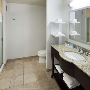Private guest bathroom with shower and free toiletries at Hampton Inn Los Angeles-Orange County-Cypress.