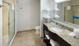 Private guest bathroom with shower and free toiletries at Hampton Inn Los Angeles-Orange County-Cypress.