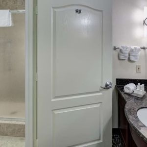 Private guest bathroom with shower and free toiletries at Homewood Suites By Hilton Agoura Hills.