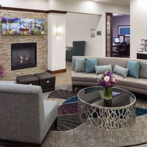 Lobby lounge with fireplace and workspace at Homewood Suites By Hilton Agoura Hills.