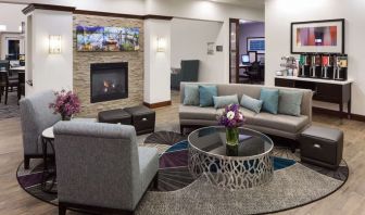 Lobby lounge with fireplace and workspace at Homewood Suites By Hilton Agoura Hills.