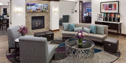 Lobby lounge with fireplace and workspace at Homewood Suites By Hilton Agoura Hills.