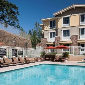 Outdoor pool with lounge chairs at Homewood Suites By Hilton Agoura Hills.