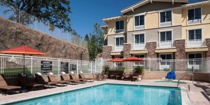 Outdoor pool with lounge chairs at Homewood Suites By Hilton Agoura Hills.