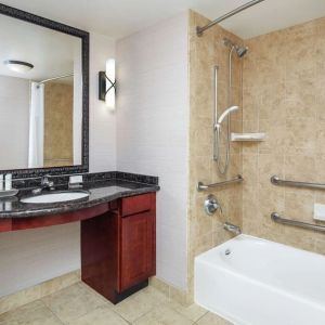 Private guest bathroom with combined shower and tub at Homewood Suites By Hilton Agoura Hills.