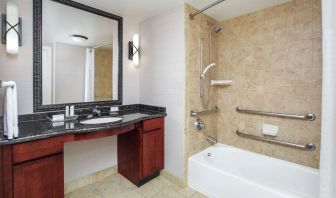 Private guest bathroom with combined shower and tub at Homewood Suites By Hilton Agoura Hills.