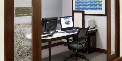 Business center with computers, printer and ergonomic chairs at Homewood Suites By Hilton Agoura Hills.