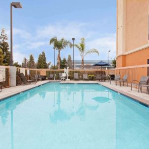 Outdoor pool with lounge chairs at Hampton Inn & Suites Clovis-Airport North.