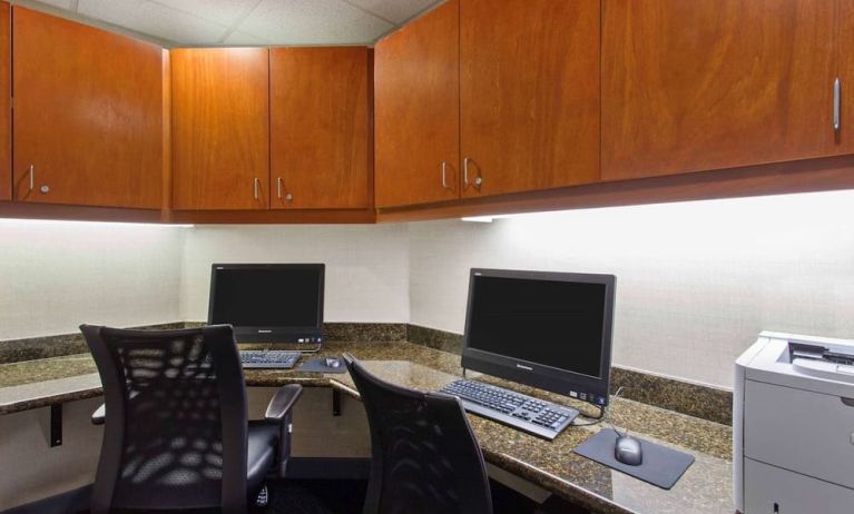 Business center with computers, printer and ergonomic chairs at Hampton Inn & Suites Clovis-Airport North.