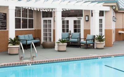 Outdoor pool with lounge chairs at Homewood Suites By Hilton San Jose Airport-Silicon Valley.