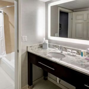 Private guest bathroom with combined tub and shower atHomewood Suites By Hilton San Jose Airport-Silicon Valley.