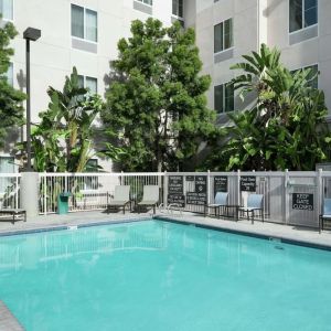 Outdoor pool with lounge chairs at Homewood Suites By Hilton Fresno Airport/Clovis.