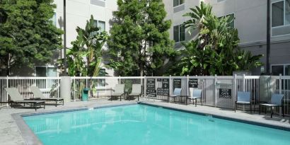 Outdoor pool with lounge chairs at Homewood Suites By Hilton Fresno Airport/Clovis.