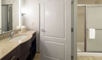 Private guest bathroom with shower and free toiletries at Homewood Suites By Hilton Fresno Airport/Clovis.