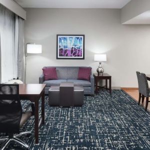 Day use room's workspace and lounge area at Homewood Suites By Hilton Fresno Airport/Clovis.