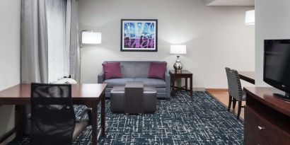 Day use room's workspace and lounge area at Homewood Suites By Hilton Fresno Airport/Clovis.