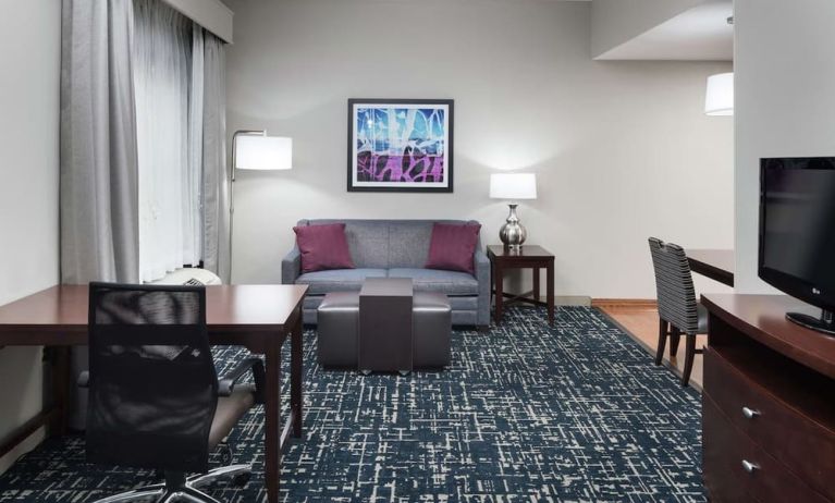 Day use room's workspace and lounge area at Homewood Suites By Hilton Fresno Airport/Clovis.