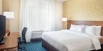 King room with work desk and TV at Fairfield Inn & Suites By Marriott North Bergen.
