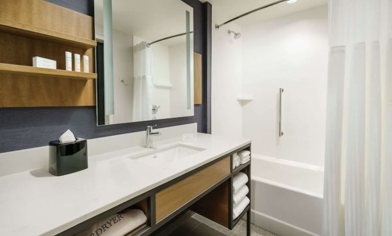 Private guest bathroom with combined shower and tub at Hilton Garden Inn Sunnyvale.